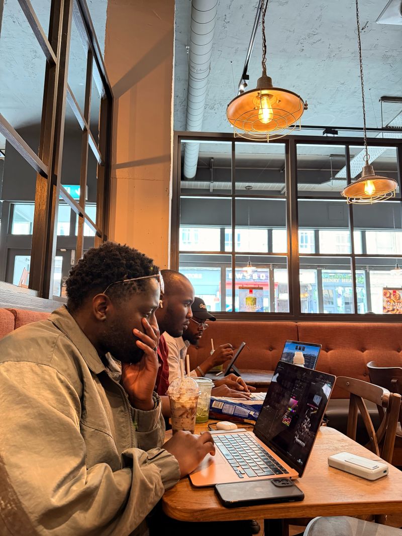 Caleb working on a laptop in a café